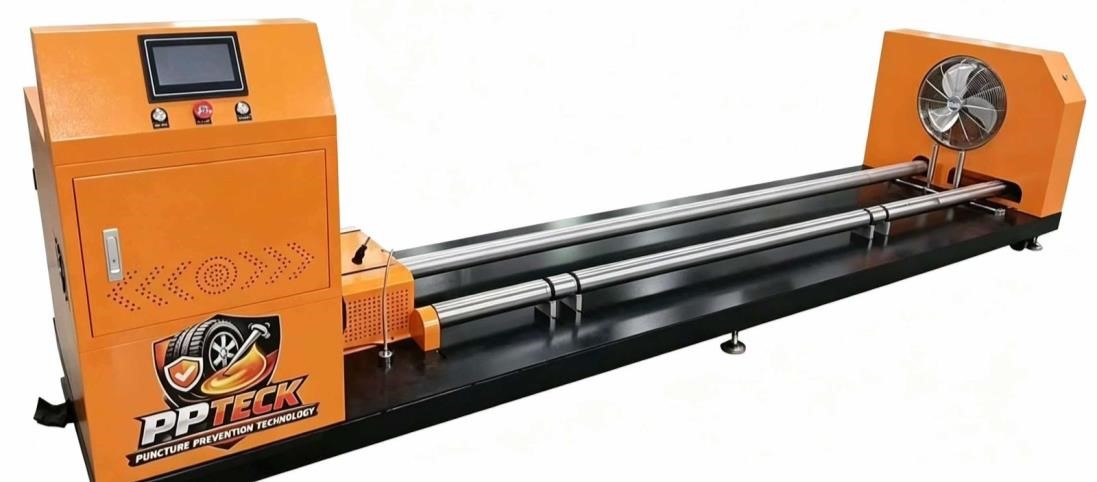 An orange PP Teck polymer installation machine with a long arm on a black frame