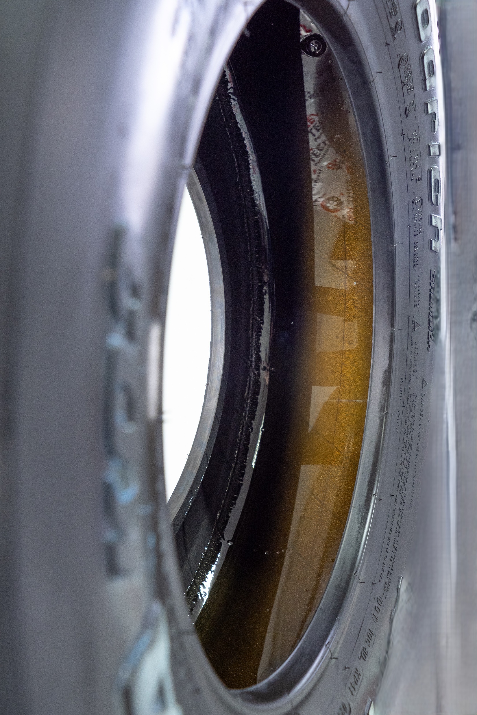 A close-up of the inside of a tire coated with an amber nano polymer layer